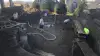 Several workers are constructing an in-ground swimming pool in a residential backyard.