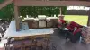Backyard outdoor kitchen with grill and bar seating