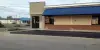 A parking lot outside of a fast food restaurant.