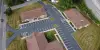 Aerial view of three buildings with a newly-paved parking lot.