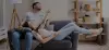 man and woman laying on couch
