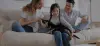 family and dog sitting on couch