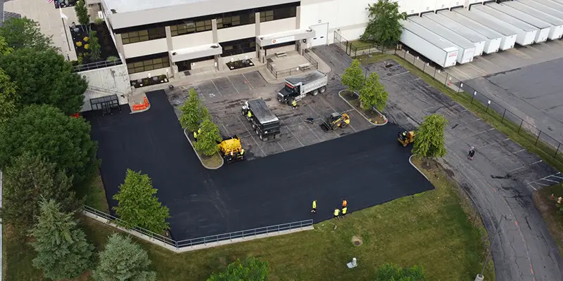 An aerial view of a new blacktop in front of a building.