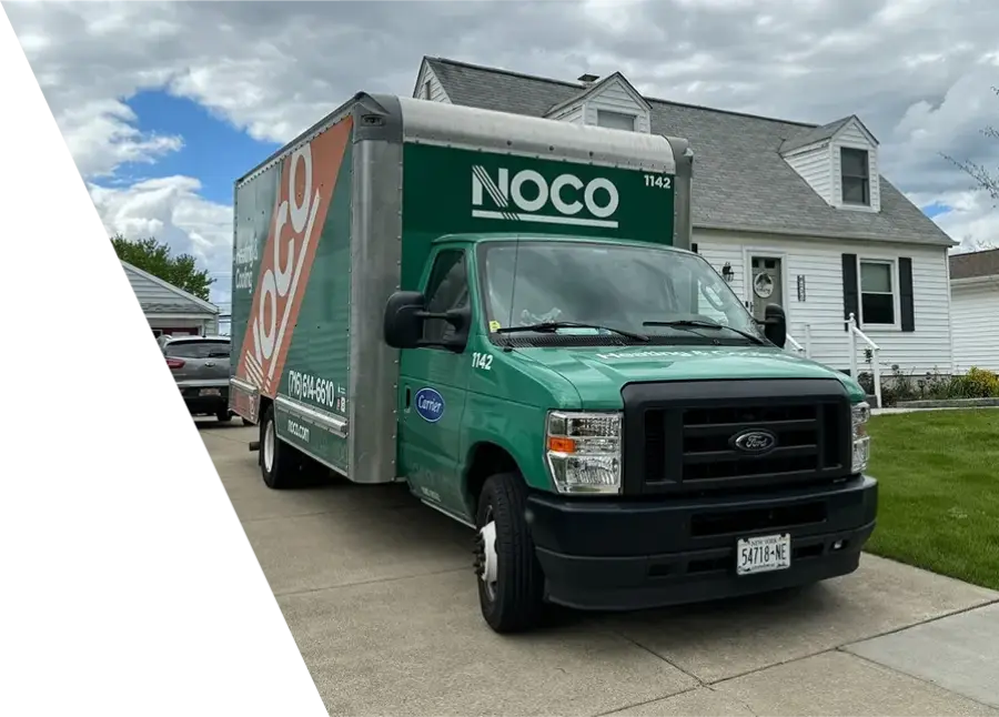 NOCO green service truck parked in front of a residential home
